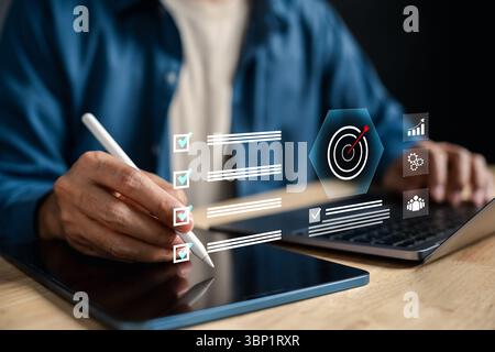 Target planning and goal setting for business success, digital checklist and dartboard on tablet Stock Photo