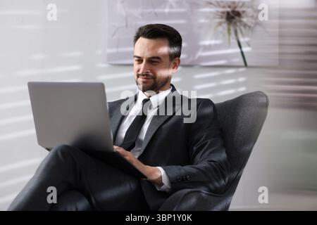Professional psychologist having online consultation with his client via laptop indoors Stock Photo