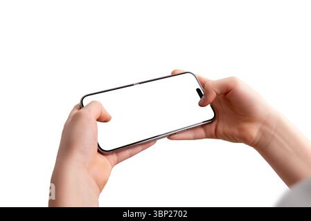 Close-up of a smartphone held horizontally in a boy’s hands, focusing on the screen. Isolated display and background, ideal for video game or app mock Stock Photo