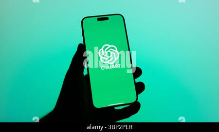 This image shows the ChatGPT logo clearly displayed on the screen of an iPhone, representing the popular AI assistant app interface in a modern tech s Stock Photo