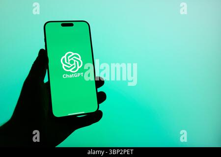This image shows the ChatGPT logo clearly displayed on the screen of an iPhone, representing the popular AI assistant app interface in a modern tech s Stock Photo