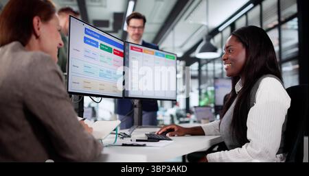 Busy Young Project Manager Organizes Team Schedule With Kanban Software. Stock Photo