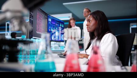 Scientist Conducts Research In Manufacturing Laboratory Using Technology Stock Photo
