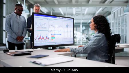Analyzing Data On KPI Dashboard: A Multicultural Team In Business Stock Photo