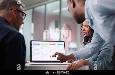 Busy Business Analyst Uses Software To Plan Multiracial Team's Schedule. Stock Photo
