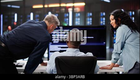 Agile Professionals Collaborate On Programming Efficiency In Diverse Team Setting. Stock Photo