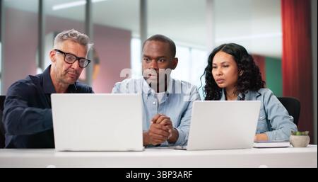 African And Hispanic Designers Working Together On Innovative Marketing Strategy. Stock Photo