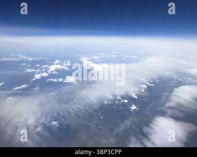 View from aeroplane at high altitude on white clouds Altostratus moving over coastal region of Mediterranean, Greece, Europe Stock Photo