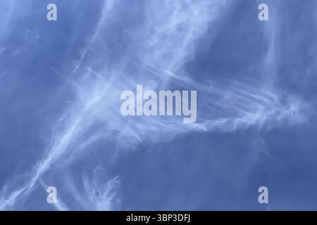 Fibrous veil clouds Feather clouds Cirrus in front of blue sky. international Stock Photo