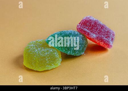 Jelly candies or gummy candies on paper colored background Stock Photo