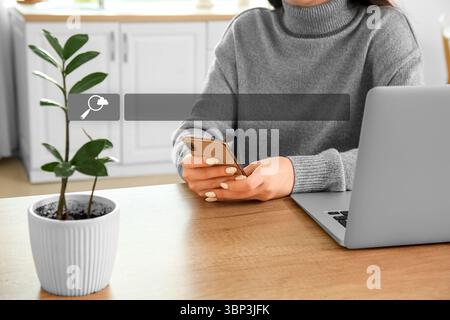 Woman with laptop and mobile phone using web search engine at home Stock Photo