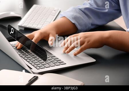 Woman with laptop using web search engine in office Stock Photo