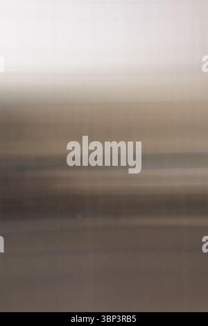 Alumiun siding's blurred neutral toned horizontal lines create abstract motion effect highlighting subtle gradients and blends of light and shadow. Stock Photo