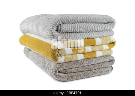 Soft fluffy striped grey and yellow bath towels folded in stack isolated on white background. Terry cloth, striped pattern towel texture, cotton bath Stock Photo