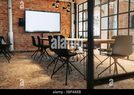 Chairs arranged around table in meeting room at office Stock Photo