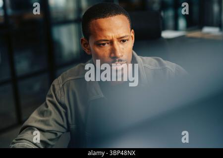 Focused businessman working on computer at office Stock Photo