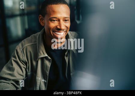 Happy businessman in smart casuals working at office Stock Photo