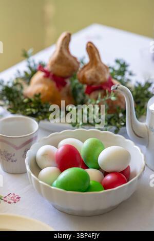 Easter celebration table with colorful eggs and decorative bunnies Stock Photo