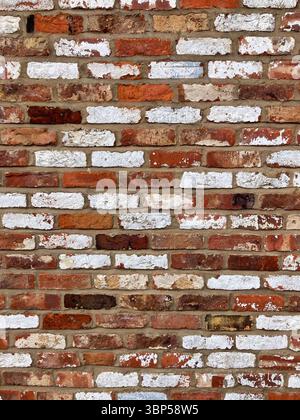 close up full frame red brick wall some painted white brickwork background Stock Photo