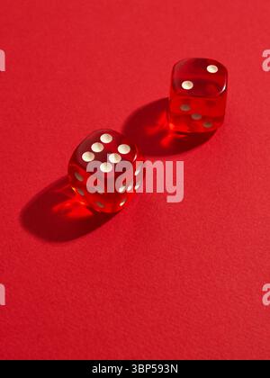Red and white dices on a red background Stock Photo