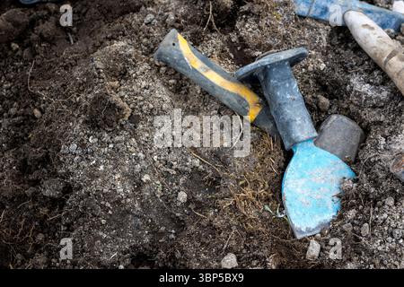 Tools of a stone kason, working on a landscape garden project Stock Photo