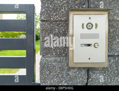 Stainless steel intercom on brick pillar Stock Photo