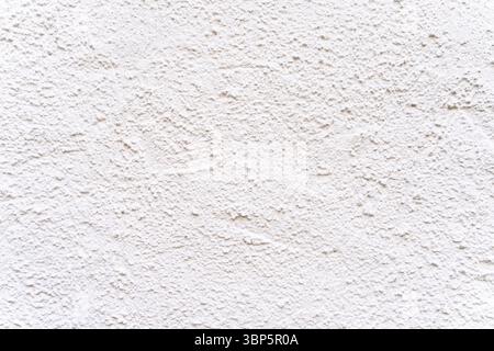 White textured plaster wall surface with rough grain pattern. Stock Photo