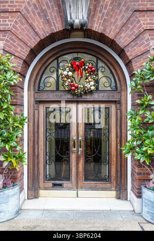 Decorative Christmas wreath hangs on a front door of a house in London, England, United Kingdom, UK Stock Photo