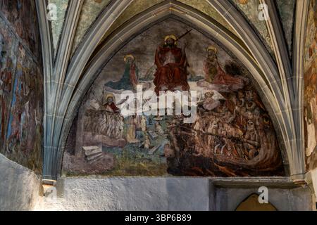 A fresco in Constance Minster depicts the Last Judgement. Christ is enthroned in the centre. Angels and saints surround him. On the left, people rise from the grave and are saved. On the right, the damned are dragged into hell by demons. Theatergasse, Konstanz, Baden-Württemberg, Germany Stock Photo