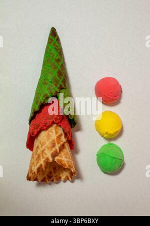 Multicolored cones and ice cream scoops on grey backround. Vibrant colors Stock Photo