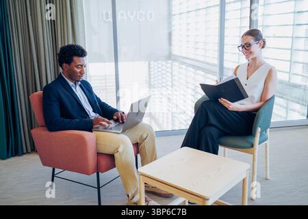Engaging in a Collaborative Meeting within a Modern Workspace Environment with Purposeful Dialogue Stock Photo