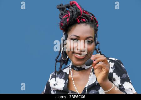 Friendly Black woman customer service representative with headset smiling confidently. Perfect for call center, customer support, business communicati Stock Photo