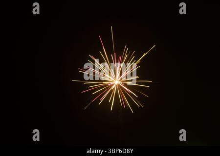 New Year’s Eve fireworks lighting up the night sky over cityscape in Estonia Stock Photo
