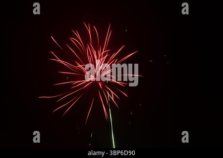 Colorful fireworks exploding in the night sky during celebration, long exposure Stock Photo