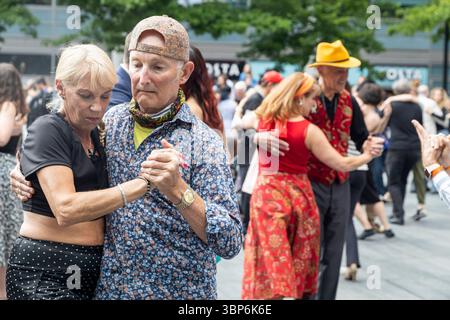 London, UK, 9 May 2025 Senior Dancers Engage in a Passionate Tango Outdoors. Stock Photo