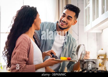 Happy Middle Eastern Spouses Preparing Lunch Together In Kitchen Stock Photo