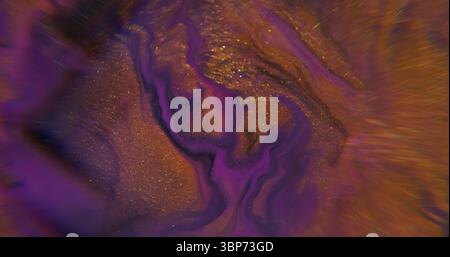 Fluid spill. Water art. Defocused purple golden neon color splash paint in liquid shiny dark black stains floating on abstract light background. Stock Photo