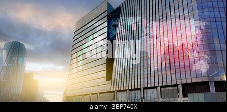 Modern corporate headquarters office with glass facade reflecting digital world map. Global business network, technology leadership, and international Stock Photo