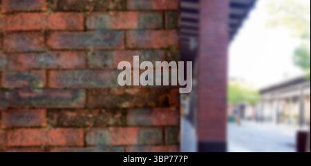 Flat design is showing brick wall filling left side, blurred columns supporting canopy and walkway Stock Photo