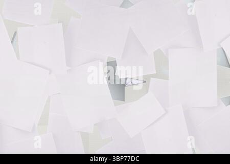 Flat design showing blank sheets scattering across workspace with grid mat, folded triangle Stock Photo