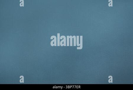 Textured blue fabric background is showing subtle shading and grainy pattern in flat design Stock Photo