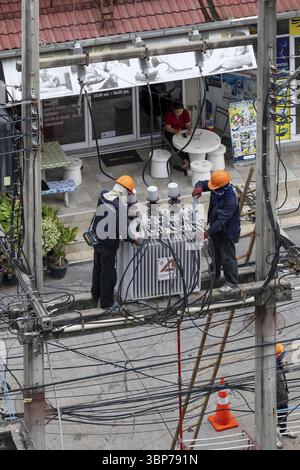 Electricians working on power lines, Pattaya, Thailand, Asia Stock Photo