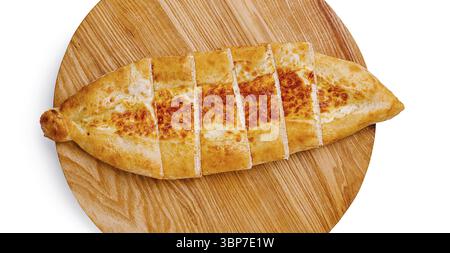 Food, A freshly baked khachapuri, a Georgian cheese bread, is sliced into equal portions and presented on a round wooden board. The golden crust and m Stock Photo