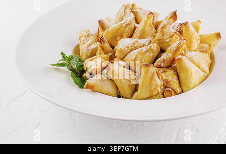 Food, Delicious glazed apples pancakes garnished with a mint leaf, served on a clean white background Stock Photo