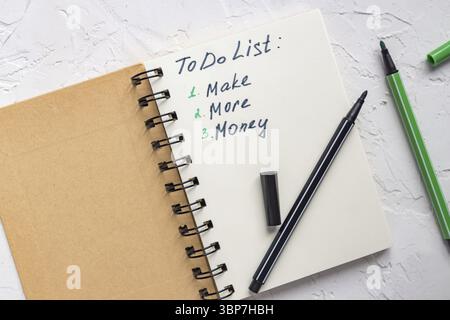 To do list - make more monTo do list - make more money written text on note pad. Close upe written text on note pad Stock Photo