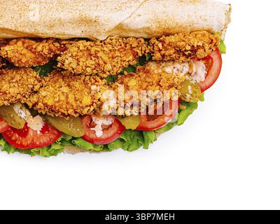 Food, A crispy chicken sandwich features golden fried chicken strips, fresh lettuce, sliced tomatoes, pickles, and a creamy sauce, all served in a sof Stock Photo
