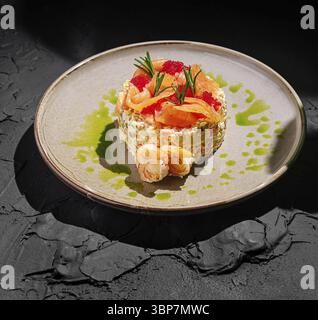 Food, A beautifully arranged seafood salad featuring shrimp and salmon, garnished with fresh herbs and colorful sauces. The dish is presented on a tex Stock Photo