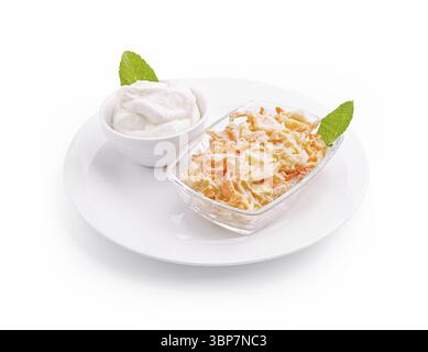 Food, A colorful carrot salad topped with yogurt dressing is beautifully presented with mint leaves on a clean white plate. This dish adds a refreshin Stock Photo