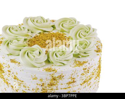 Food, Delicious pistachio cake with green butter cream rosettes decoration and finely chopped pistachios, isolated on white background Stock Photo