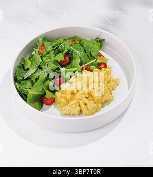 Food, Plate combining the richness of scrambled eggs with the freshness of a salad, perfect for a healthy and fulfilling breakfast Stock Photo